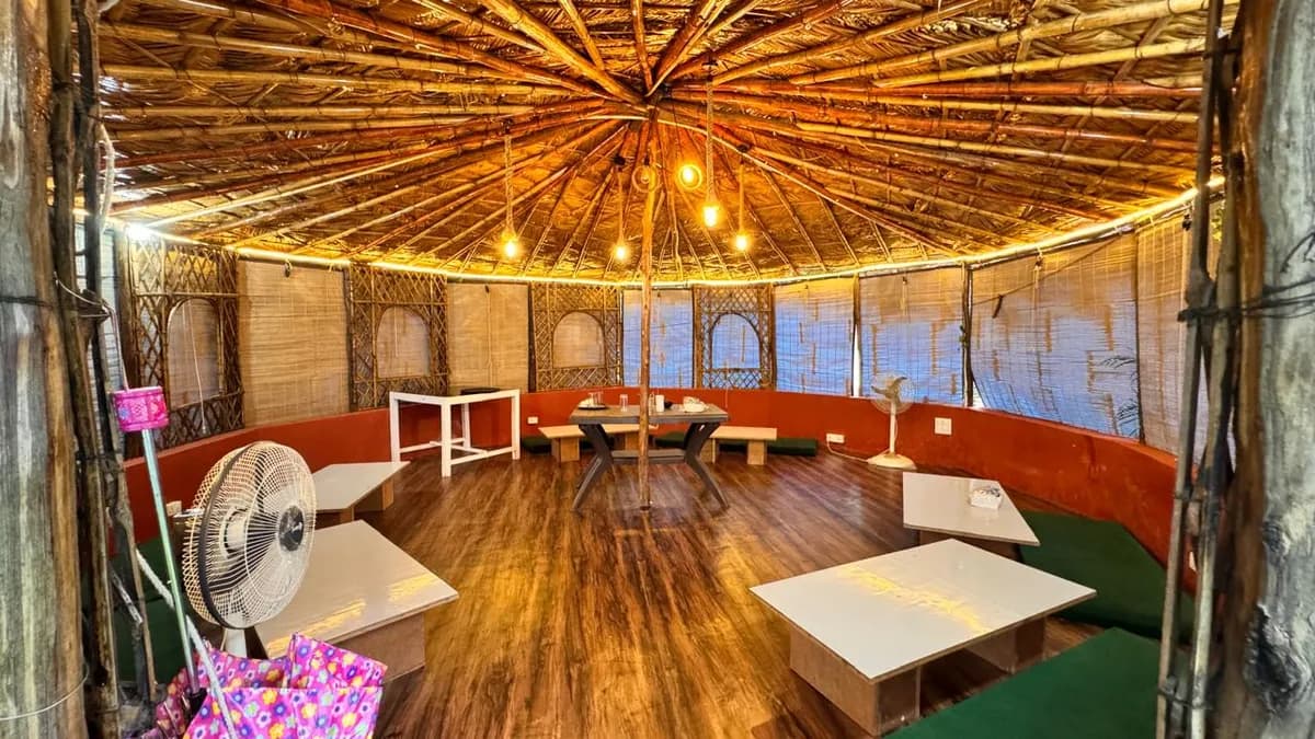 Round bamboo common hall with low tables for meditation and study at the Rishikesh yoga school