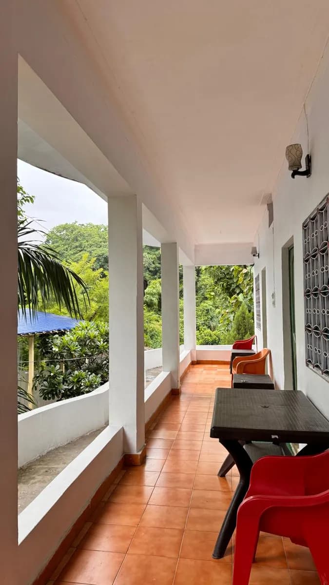 Forest-view balcony with seating at our residential yoga teacher training campus in Rishikesh
