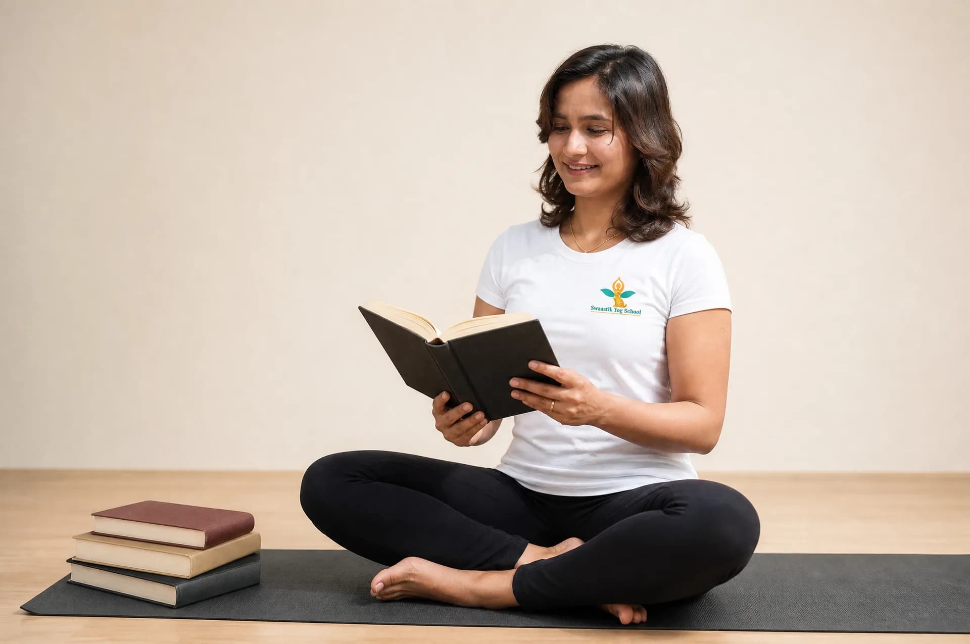 Yoga teacher training student studying course manuals and yoga philosophy books
