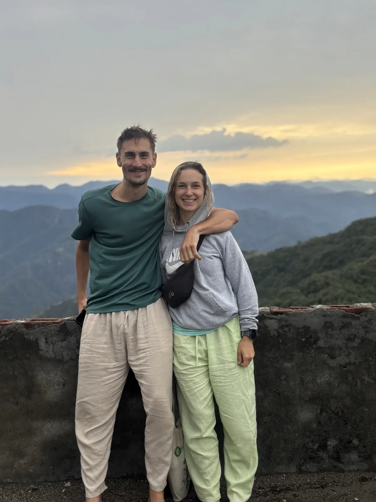 Two yoga students at a Himalayan sunset viewpoint near Rishikesh