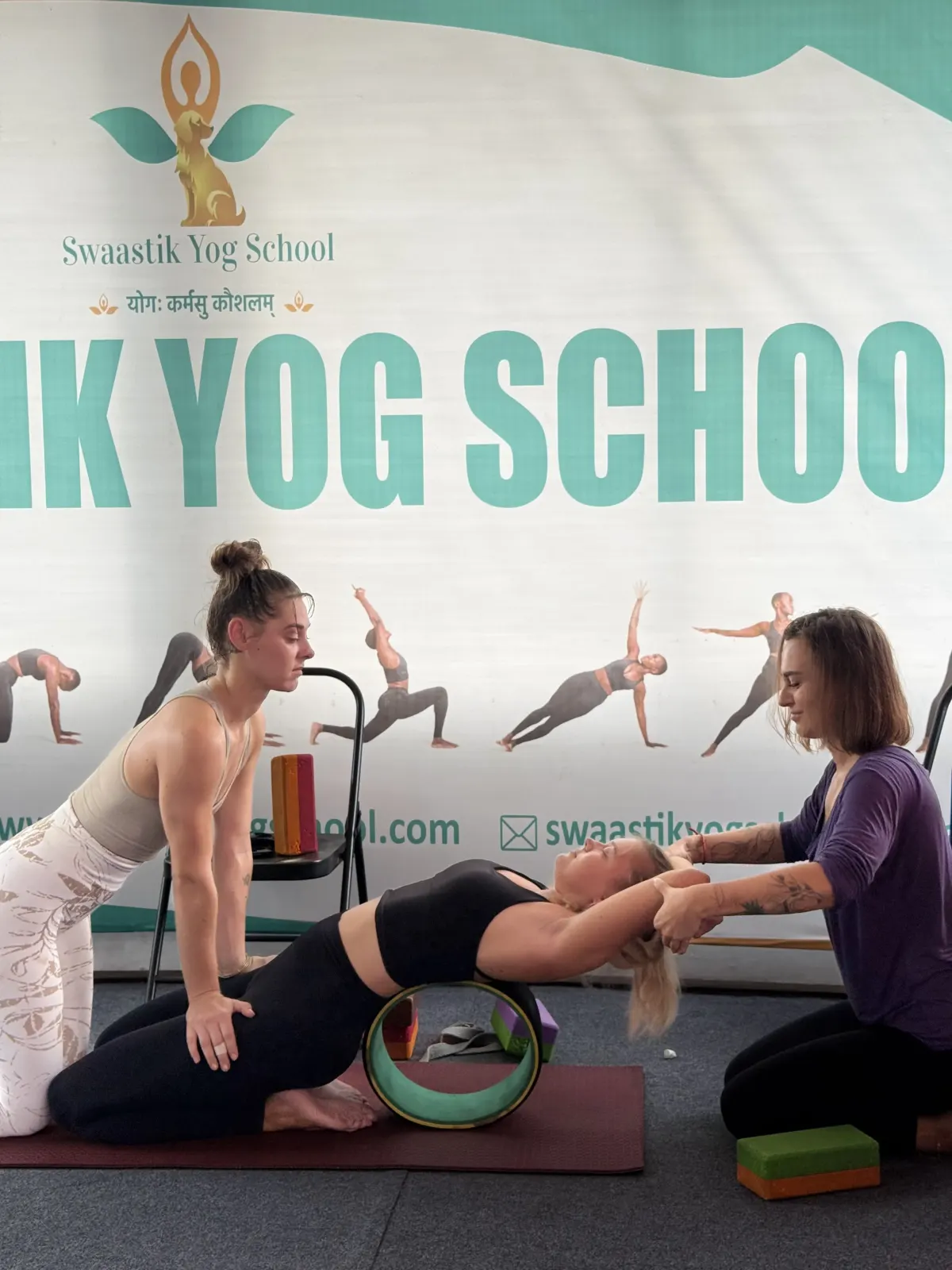 Swaastik Yog School teacher guiding a student through an asana